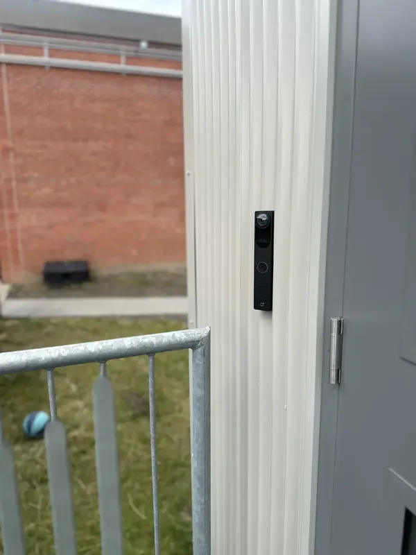 Video intercom installed beside an exterior commercial entry door